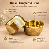 Features image of handcrafted brass hammered bowl highlighting the polished brass interior, intricate engraved floral design, decorative beaded rim, premium gold finish and multipurpose serving use for sweets, snacks, dry fruits and festive table presentation.