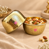 Handcrafted brass bowl used for serving mixed dry fruits including almonds, cashews, pistachios and raisins, styled in a premium beige lifestyle setting to show its use for festive serving, dining tables, special occasions and traditional home entertaining.