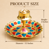 Brass Incense Stick Holder size guide showing a decorative round brass agarbatti stand measuring 3.5 inches in diameter and 2 inches in height. Features a polished golden brass central holder with multiple holes for placing incense sticks, a raised pedestal and a circular decorative base with intricate red and blue enamel-style floral patterns. The dimensional illustration highlights its compact tabletop design, suitable for pooja rooms, home temples, daily incense rituals and traditional festive decoration