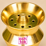 Close-up product photograph of a Brass Kalash Shape incense holder highlighting the polished golden brass interior, raised textured central cone, circular openings surrounding the centre, smooth flared rim, and fine concentric machining details. The detailed view showcases the traditional craftsmanship, reflective brass finish, and carefully formed kalash-style structure of this compact pooja accessory for religious rituals and home mandir use.