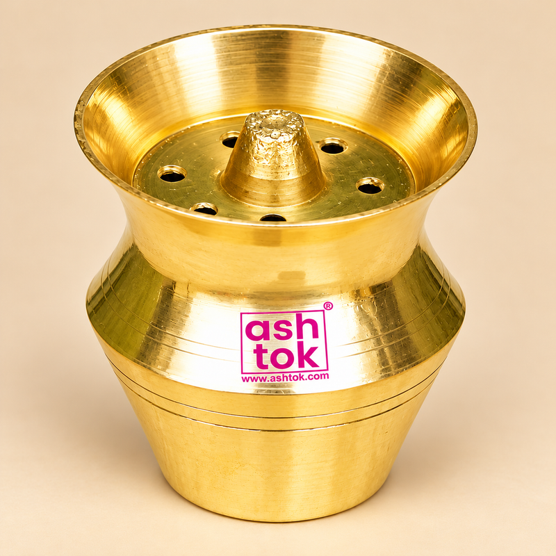 Three-quarter angle view of a traditional Brass Kalash Shape incense holder showcasing its shiny golden brass surface, broad flared upper rim, narrow curved middle section, rounded decorative body, and raised central holder surrounded by circular openings. The compact brass accessory measures 2 inches in height and 2 inches in diameter and features an elegant traditional design suitable for pooja rooms, religious rituals, and temple accessories.