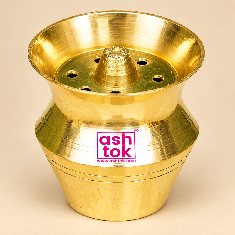 Traditional Brass Kalash Shape pooja incense holder with a polished golden brass finish, wide flared circular opening, raised central holder, multiple round holes arranged around the centre, and beautifully curved kalash-style body. Featuring fine horizontal decorative grooves and a compact 2-inch height and 2-inch diameter, this brass pooja accessory is suitable for home mandirs, daily prayers, traditional religious ceremonies, and festive pooja arrangements.