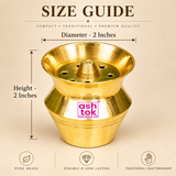 Brass Kalash Shape product dimension guide showing an overall height of 2 inches and diameter of 2 inches. The compact golden brass pooja accessory features a wide flared upper opening, central raised holder, circular holes, decorative horizontal grooves, and traditional kalash-shaped body. The size illustration helps customers understand the dimensions of this small brass item for home mandirs, daily worship, pooja arrangements, and religious ceremonies.