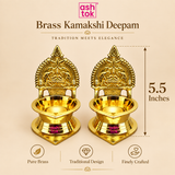 Pair of Brass Kamakshi Deepam lamps presented in a premium beige layout with the height marked as 5.5 inches. The image shows two identical traditional brass lamps with a shiny finish, temple-inspired ornamental backplate, deep diya cup, and circular stepped base. The design conveys a balanced size for home temple use, spiritual décor, festive celebrations, and return gifting while emphasizing the quality of the polished brass construction.