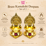 Informative product features image for Brass Kamakshi Deepam set of 2 on a beige background. The image shows two polished brass lamps in the center along with text and icons highlighting features such as polished brass finish, traditional design, set of 2 pieces, and suitability for pooja and gifting. The visual communicates the spiritual appeal, fine craftsmanship, and practical use of the lamps for home temples, festive occasions, and devotional décor.
