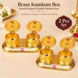 Set of 2 Brass Kumkum Boxes displayed together on a premium beige background, each featuring two round covered compartments on a decorative oval base, suitable for festive gifting, wedding return gifts, housewarming and religious occasions.