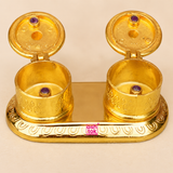 Detailed close-up of Brass Kumkum Box with both hinged lids open, highlighting the smooth golden interiors, embossed outer patterns, decorative lid detailing, purple stone accents, polished oval base and fine traditional craftsmanship of the double sindoor container.