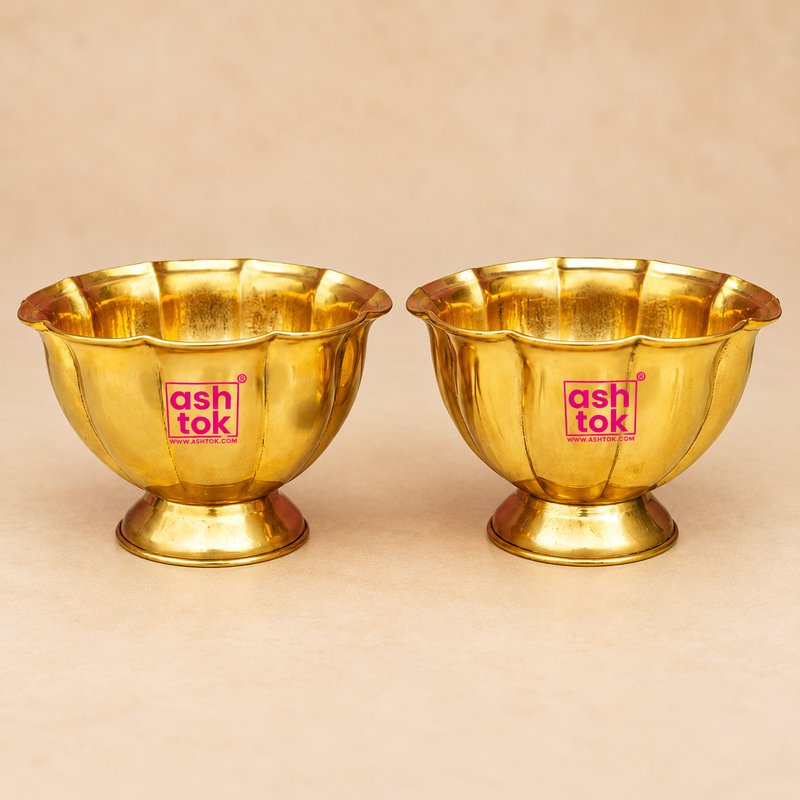 Brass Lotus Chandan Cup with a polished golden finish, scalloped lotus petal rim, rounded handcrafted body and sturdy pedestal base, displayed as a matching pair on a premium beige studio background for puja and traditional use.