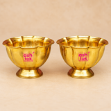 Brass Lotus Chandan Cup with a polished golden finish, scalloped lotus petal rim, rounded handcrafted body and sturdy pedestal base, displayed as a matching pair on a premium beige studio background for puja and traditional use.