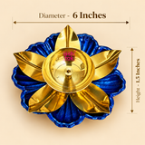 Size guide of a decorative brass lotus diya featuring a golden brass oil bowl with a central wick holder, polished golden flower petals and a royal blue lotus-shaped base with textured detailing. The product measures 6 inches in diameter and 1.5 inches in height, making it suitable for traditional puja rituals, Diwali lighting arrangements, home temple decoration and festive displays.
