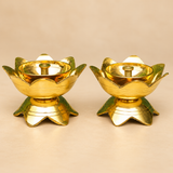 Brass Lotus Diya Set of 2 Pcs featuring two matching traditional brass pooja oil lamps with an elegant polished golden finish, beautifully shaped upward-facing lotus flower petals, smooth circular inner oil bowls, raised cylindrical central wick holders, and decorative lotus-shaped pedestal bases. Each brass diya measures 3 inches in diameter and 2 inches in height. Displayed side by side against a premium beige studio background, these traditional brass lotus diyas are suitable for daily pooja, home mandir