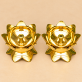 Elevated top-view photograph of a Brass Lotus Diya Set of 2 Pcs showcasing the polished golden interiors of two matching traditional oil lamps. Each diya features an elegant arrangement of upward-facing lotus petals surrounding a smooth circular brass oil bowl with a centrally positioned cylindrical wick holder and small circular opening. The detailed top perspective highlights the symmetrical lotus flower design, reflective brass finish, and traditional craftsmanship of these compact decorative brass pooja