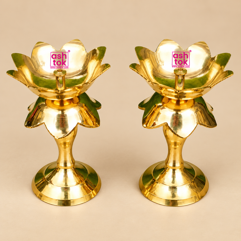 Pair of traditional Brass Lotus Diya Stands featuring a beautiful lotus flower design, polished golden brass surface, decorative layered petals, central oil wick holders and sturdy round pedestal bases. Each diya stand measures 2.5 inches in diameter and 5.5 inches in height. Suitable for daily pooja, home mandir decoration, Diwali celebrations, festive lighting, religious ceremonies and traditional home decor.