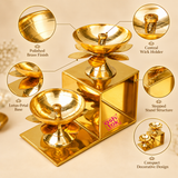 Detailed features image of the Brass Lotus Diya with Stand highlighting its polished golden brass finish, traditional lotus flower design, central oil wick holders, smooth rounded diya bowls and geometric stepped stand structure. The two diya holders are positioned at different heights on a rectangular brass base, with decorative lotus petals beneath each bowl and carefully shaped pedestal supports. The close-up sections showcase the reflective metal surface, elegant petal detailing and compact tabletop des
