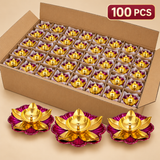Traditional brass lotus diya set of 100 pieces featuring a polished golden brass finish with decorative pink lotus-shaped bases, neatly arranged in a compartmentalized cardboard box with protective wrapping. Ideal for Diwali celebrations, temple puja, festive decorations, wedding return gifts and bulk gifting
