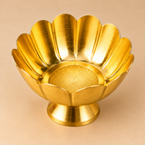 Angled interior view of a decorative brass lotus flower bowl showcasing its polished golden finish, wide open floral shape, raised curved petals and intricately patterned circular inner base. The traditional brass bowl stands on a flared pedestal and features a scalloped lotus-inspired rim, making it suitable for festive home decoration, flower offerings, decorative arrangements and traditional return gifts.