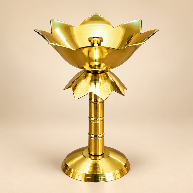 Brass Lotus Stand Diya with a polished golden brass finish, lotus-shaped diya bowl, central wick holder, turned brass stem and wide stable round base, photographed as a clean product image on a soft beige background with ASHTOK branding, suitable for festive décor, home ambience, traditional lighting and gifting.