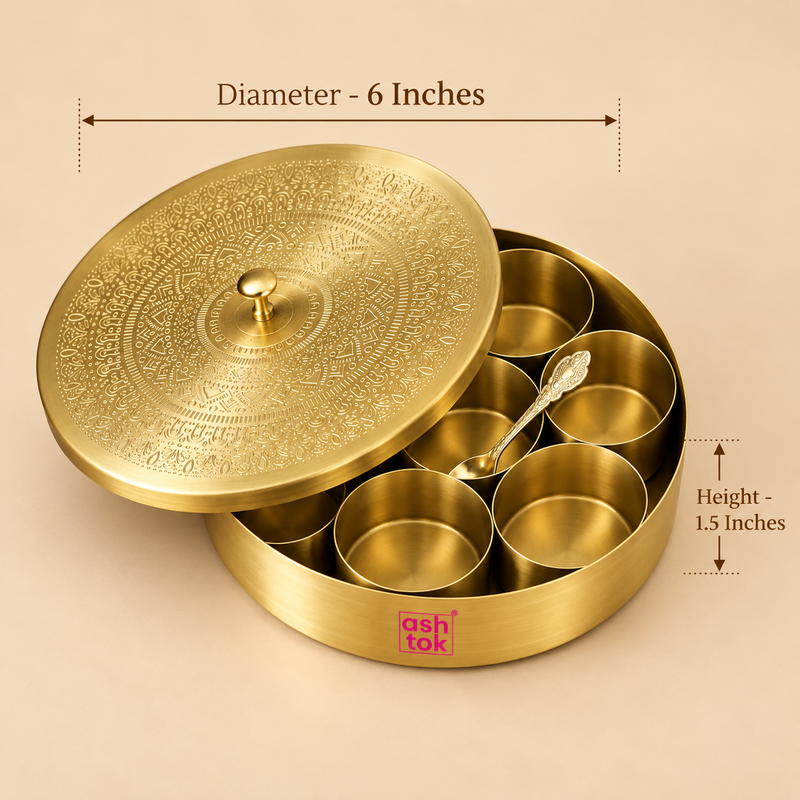 Size guide image of a round brass masala box showing approximately 6 inches diameter and 1.5 inches height, presented on a warm beige studio background with clear measurement arrows. The traditional spice storage box includes seven removable brass bowls, a matching serving spoon and an intricately engraved lid with a small central knob.