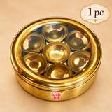 Single brass masala box with transparent glass lid and seven inner spice bowls, displayed on a premium beige background for individual kitchen use and gifting.