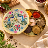 Brass masala box shown in a lifestyle setting with spices filled inside the compartments, including colorful everyday masalas arranged neatly in the inner bowls, with the decorative meenakari lid partially open to show its practical kitchen use and traditional appeal.
