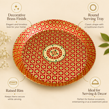 Product feature infographic of a round red and gold Meenakari brass tray. Four circular callouts highlight key features: 'Decorative Brass Finish' with an elegant look, 'Round Serving Tray' showcasing classic shape, 'Raised Rim' for keeping items secure, and 'Ideal for Serving & Decor' for festive occasions.
