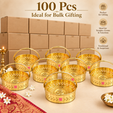 Bulk presentation of 100 Brass Oval Shape Phool Butti Temple Baskets and Puja Buttis for large gifting and event requirements, showing multiple polished golden brass baskets arranged in front of plain packaging boxes. Each basket features a sturdy curved handle, decorative cutwork body, embossed Om detailing and ASHTOK branding, suitable for wholesale orders, wedding return gifts, festival gifting, temple events, religious functions and large quantity gift distribution.
