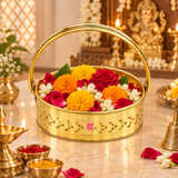 Brass Oval Shape Phool Butti used as a traditional puja flower basket in a warm devotional setting, suitable for carrying marigold flowers, jasmine, rose petals, prasad and other temple offerings. The polished golden brass basket features an oval body, curved handle, decorative cutwork sides, embossed Om base design and ASHTOK logo, making it ideal for daily puja, festivals and religious ceremonies.