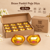 Brass Pankti Puja Diya set of 12 pieces displayed in basic cardboard carton packaging, suitable for wedding return gifts, festive gifting and pooja ceremonies.
