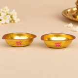Angled view of two Brass Pankti Puja Diyas featuring their polished golden finish, curved interior and traditional design for pooja and festive decoration.