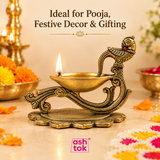 Brass diya with peacock handle lit during pooja, suitable for festive decoration, Diwali, temple use and traditional gifting.