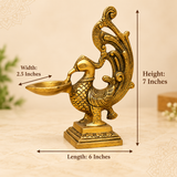 Size guide image of brass peacock diya showing approximate dimensions of 6 inches length, 2.5 inches width, and 7 inches height.