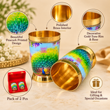Features image of peacock printed brass glasses highlighting the vibrant peacock artwork, polished brass interior, decorative gold-tone rim and base, premium finish and suitability for gifting and special occasions.