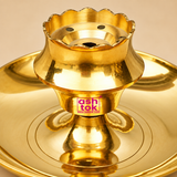 Detailed close-up image of a polished brass diya focusing on the raised central holder, flower-shaped scalloped rim, small circular ventilation holes, center opening and the reflective golden pedestal structure above the wide plate base, photographed on a premium beige studio background to showcase the brass craftsmanship, polished finish, functional oil lamp construction and fine product detailing.