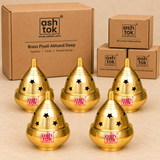 Five Brass Piyali Akhand Deep lamps displayed together with ordinary brown cardboard packaging boxes, showcasing their polished golden brass construction, traditional dome-shaped covers, star-shaped ventilation openings, and rounded oil bowl bases. Suitable for bulk pooja item purchases, temple supplies, religious return gifts, festive gifting, and ceremonial distributions.