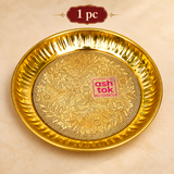 Single handcrafted brass puja plate with detailed floral engraving, polished golden finish and decorative fluted rim, presented on a premium beige background for individual puja use and gifting.