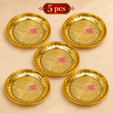 Set of 5 handcrafted brass puja plates arranged neatly on a premium beige background, each featuring intricate floral engraving and polished golden finish for gifting and religious functions.
