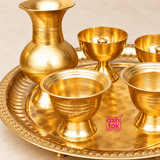 Close-up image of Brass Puja Thali Set highlighting the polished brass finish, decorative tray rim, kalash or lota, diya holders and puja bowls, showing the fine craftsmanship and traditional detailing of the set.