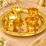 Close-up view of brass puja thali set showing the smooth polished tray and detailed diya holders with a premium handcrafted finish.