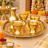 Brass puja thali set displayed in a devotional home temple setting with marigold flowers, incense, diya and traditional puja elements, showing its use for home worship, festive rituals, aarti and daily puja ceremonies.