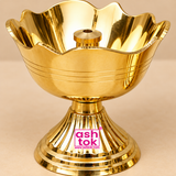 Close-up detailed view of a traditional Brass Rose Diya highlighting its polished golden brass finish, gracefully curved flower petal bowl, reflective interior surface, and central cylindrical wick holder with a circular opening for a cotton wick. The upper bowl features a distinctive scalloped floral rim resembling blooming rose petals, with smooth curved edges and three delicate parallel engraved lines decorating the exterior. The highly reflective brass surface reveals fine metallic details, warm golden 