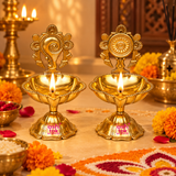 Brass Shanku Chakra Diya set of 2 used in a festive home puja setting with lit diyas, floral decorations, rangoli, and traditional brass decor.