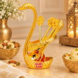 Brass Swan Spoon Stand styled in an elegant lifestyle setting for dining tables, festive occasions and home decor. The gold coated swan-shaped holder with decorative matching spoons adds a traditional and luxurious touch to serving arrangements, celebration tables, weddings, housewarming events and special occasions.