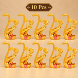 Set of 10 Brass Swan Spoon Stands displayed together for bulk gifting, featuring matching gold coated swan-shaped holders with decorative spoons. The set is suitable for wedding return gifts, festive occasions, event giveaways, family celebrations and traditional gifting requirements.