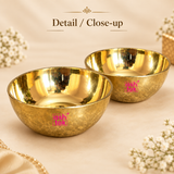 Close-up image of Brass Sweet Bowl Set showing two round brass bowls with shiny polished inner surface and textured outer finish on a beige background, highlighting product craftsmanship and elegant brass look.