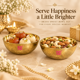 Lifestyle image of Brass Sweet Bowl Set showing two brass bowls on a beige festive setting, one filled with Indian sweets and the other with dry fruits, styled with flowers, diya and gift decor for elegant serving presentation.