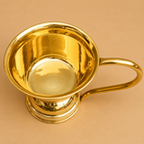 Top view of a polished brass Turkish Tandoori Chai cup with a long curved handle, ideal for serving tandoori chai, Turkish tea, herbal beverages, and specialty drinks in cafés, restaurants, and homes.