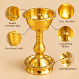 Close-up view of a Brass Udupi Nanda Diya showing the polished brass bowl, decorative beaded rim, central wick holder, and upper stem details on a beige background.