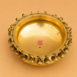 Top view of a handcrafted brass urli with decorative hanging bells around the rim, ideal for floating flowers, candles, pooja rituals, Diwali décor, weddings, housewarming, and traditional home decoration.