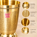 Close-up image of handcrafted brass water glass showing detailed floral engraving, polished brass rim, smooth interior surface and sturdy flared base, highlighting the fine craftsmanship and premium finish of the brass drinkware.