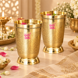 Handcrafted brass water glasses styled in a festive lifestyle setting filled for serving beverages, surrounded by flowers and traditional decor, showing their suitability for daily use, special occasions, festive serving and elegant table presentation.